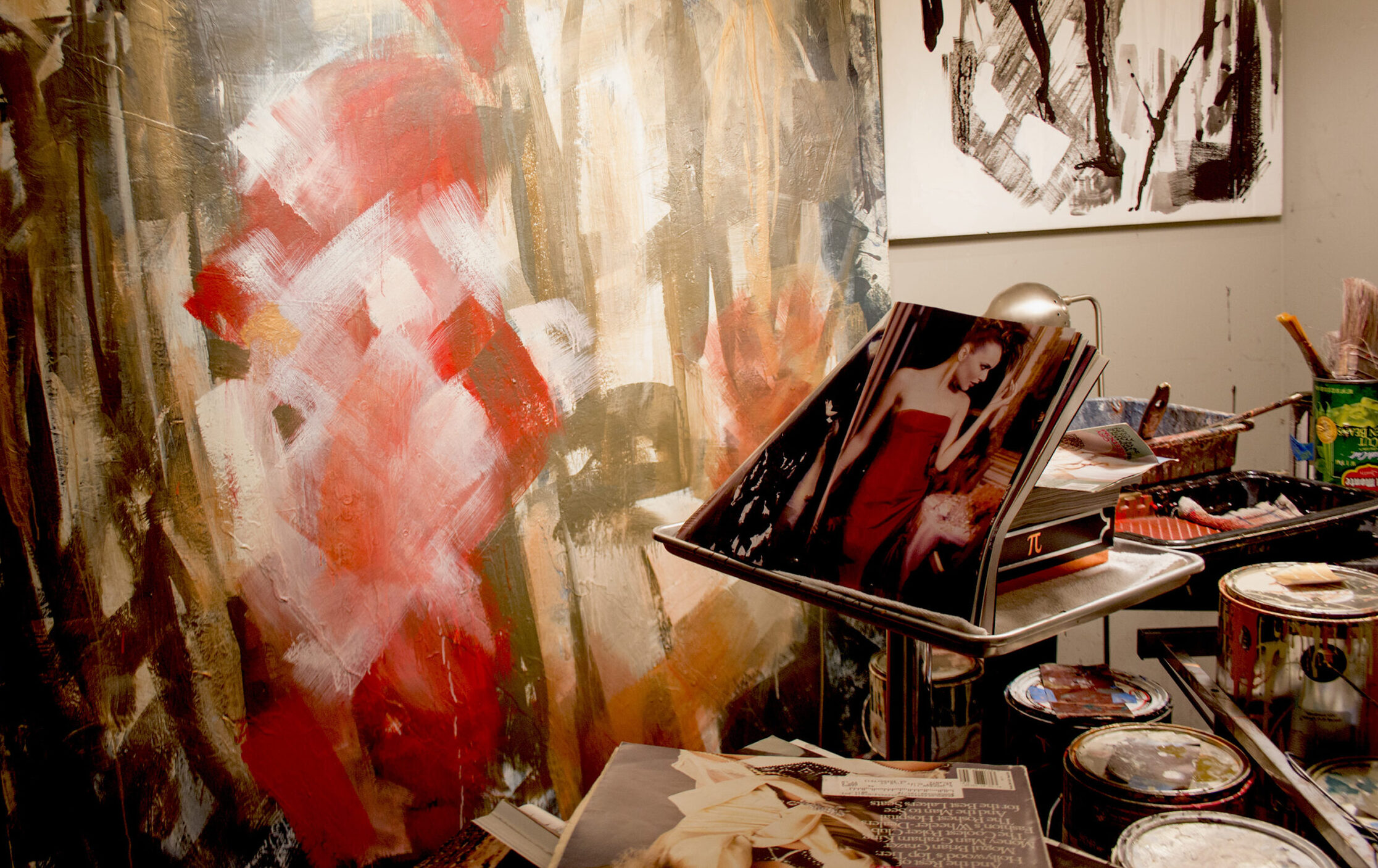 A painting of a woman in red is on display.